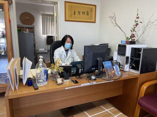 Dr. Chen is working in his office.