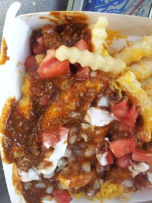 Fries, chili, onions  tomatoes, cheese, and sour cream.