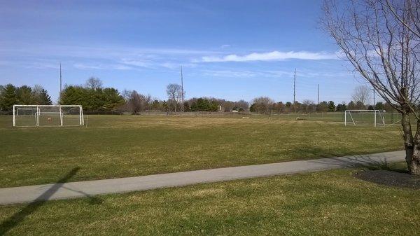 open space for soccer and a paved walking path