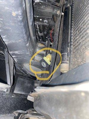 This photo shows an airbag sensor not bolted in proper location. This sensor is what deploys the airbags in a front end accident.