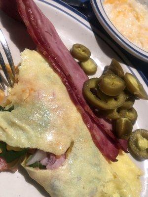 Omelette with everything, turkey bacon, Jalapeños from the salad bar, grits with cheeses added from the salad bar