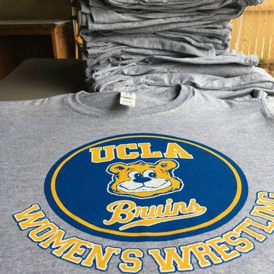 UCLA Bruins women's wrestling team shirts.