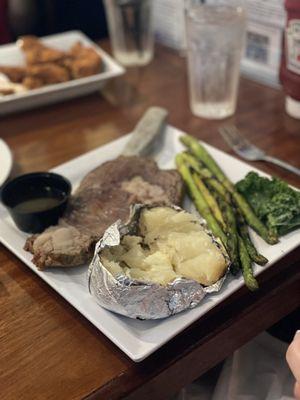 Prime rib with baked potato and asparagus