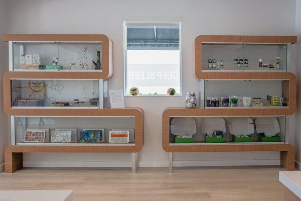 Photo of our shelves featuring a few of our smoke accessories (left) & our pain relief topical, bath & body, & bundles section (right)