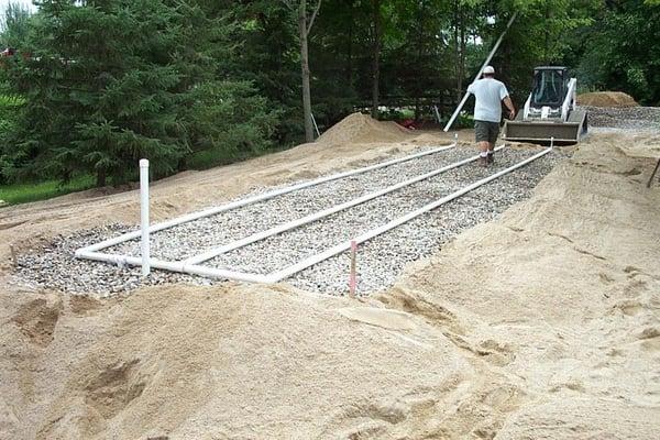 The rock bed and piping of a new mound system being installed