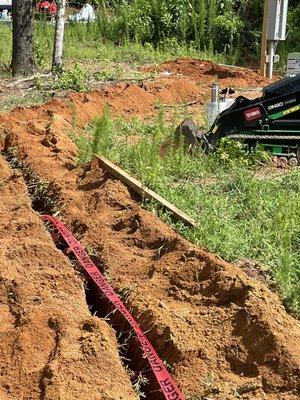 Laying underground cable for pump