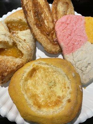 From left to right going, clockwise, - Pineapple stuffed pastry, orejas, pan dulce, pay queso