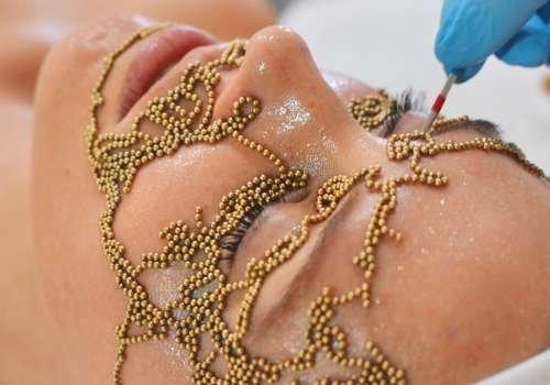 Qi beauty ritual utilizes gold magnets on acupuncture points to revitalize & rejuvenate the skin.