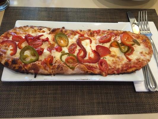 Flatbread pizza with peppers, jalapeno and cherry tomatoes.