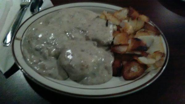 Biscuits and gravy with fried potatoes.