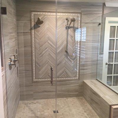 Master shower with herringbone accent mural