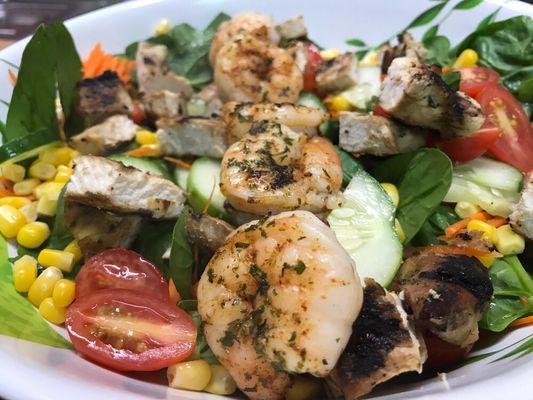 Fresh salad with grilled shrimp.