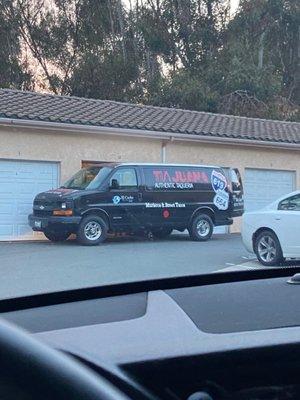 Maintenance guy unloading fish coolers into the garage he lives in.