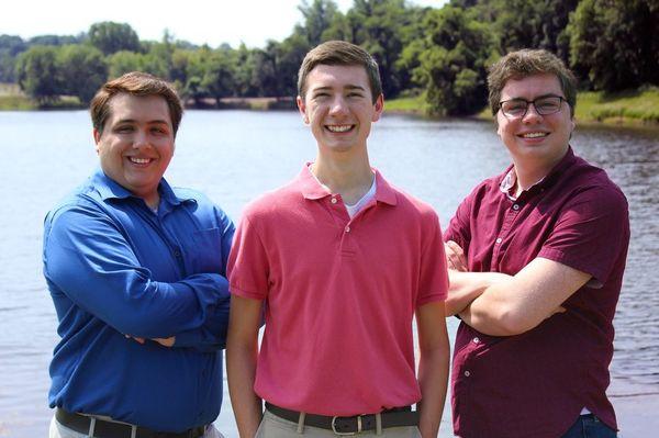 Co-owners Patrick Cymer (on left) and Max Ridenhour (at center) next to former PCMR employee Conner C.