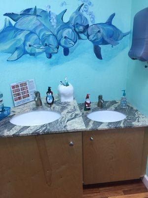 child sized sinks with playful dolphins watching over!