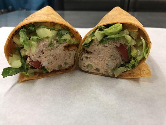 Tuna Wrap with lettuce, tomato, and onion.