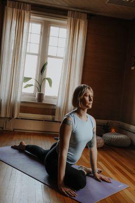 Instructor, Tracey, practicing yoga in the Blush Studio (second floor).