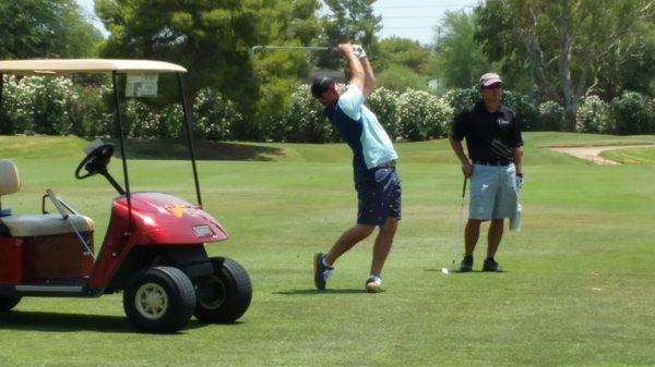 A Golf and Grow player holds his pose during his approach shot at Starfire gold course in Scottsdale, AZ