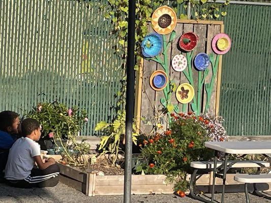 Our outdoor play area includes a garden that invites inquiry.