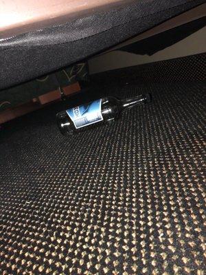 Empty Vodka bottle under the bed.