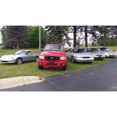 Inventory on the lawn at Colonial Motors North, Highland MI