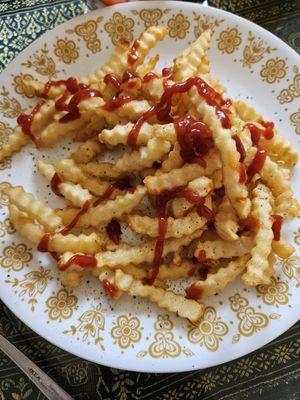 Large fries with black pepper and ketchup