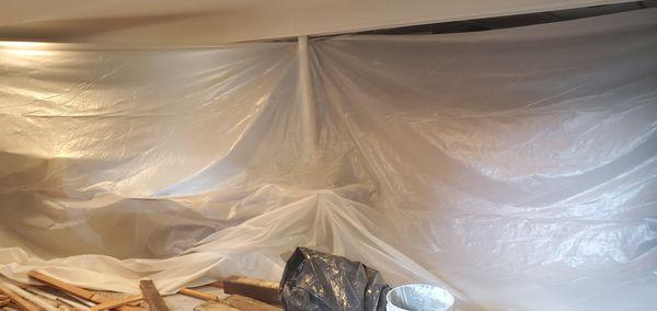 Put up plastic sheeting to help protect our furniture