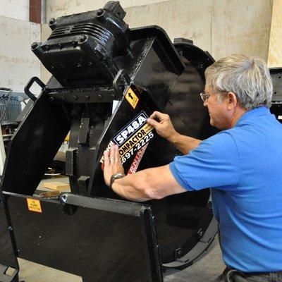 Signage being applied to the equipment.