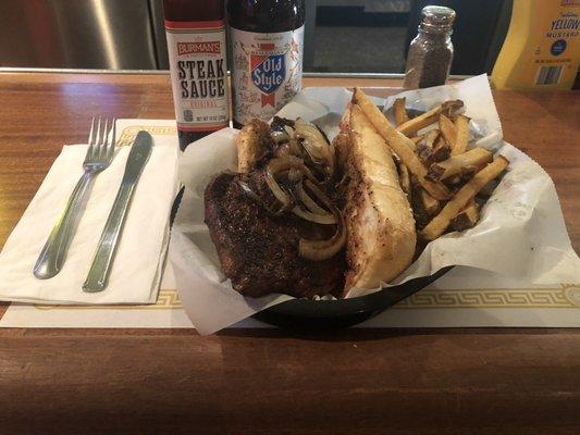 Hand-cut Ribeye Steak Sandwich with Grilled Onions and French Fried potatoes...delicious!