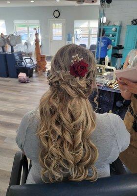 Half up curly hair with braid and added hair accessories for bride.