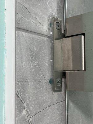 Misaligned holes for heavy glass shower door. The top left screw spins freely, suggesting it's not even in the wall anchor!