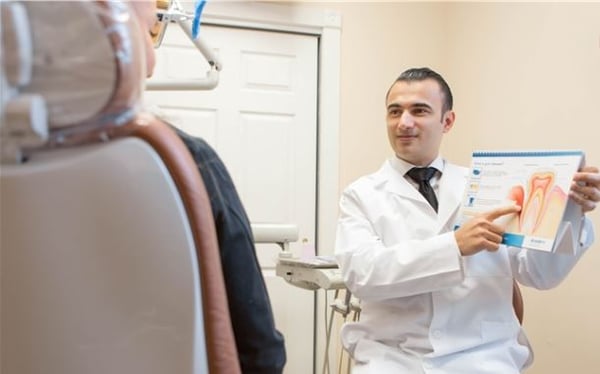 Dr. Albert teaching patient about maintaining healthy gums