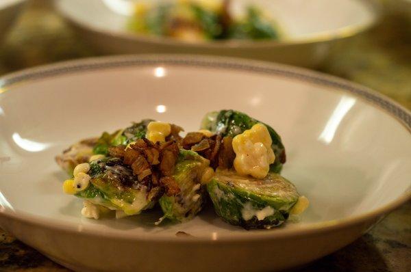 Brussel Sprout Salad with Bacon, corn, Sheep Cheese Cream, Herb Lemon Vinaigrette.