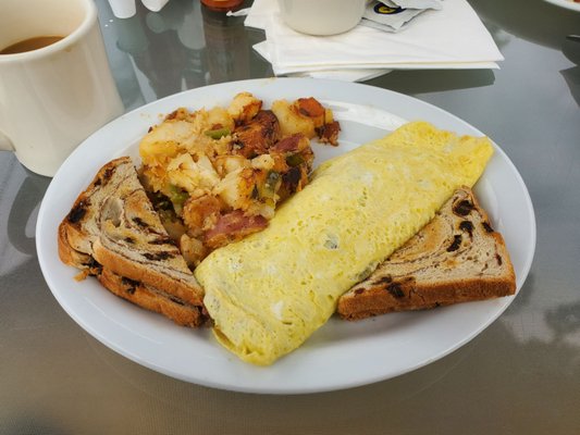 Corned beef hash omelet, cinnamon raisin bread and home fries.