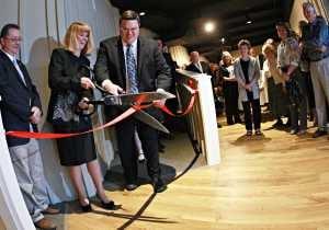 Engle Lane Member, Kathy Missel, cuts the ribbon celebrating the opening of the rebuilt theater