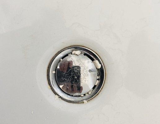 Debris from tool cleaning in new bathroom sink.