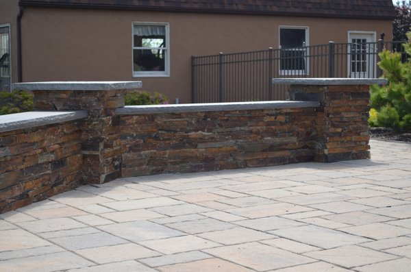 Sitting Wall, featuring natural stone facing with blue stone capping.