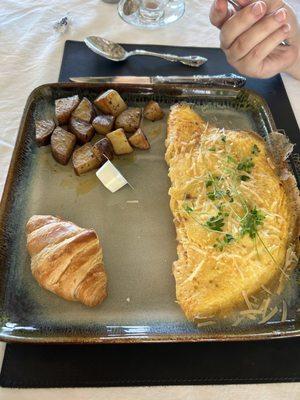 Spanish omelet, home fries, and croissant