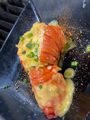 Steamed lobster tail topped with a citrus butter and scallions.