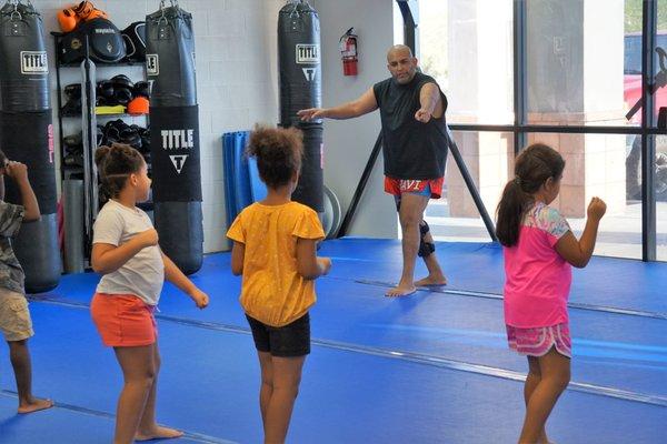 Our Muay Thai coach Javier instructing a kid's class