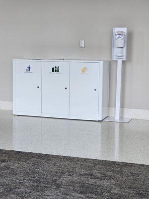 Trash & recycling receptacles with hand sanitizing stations.