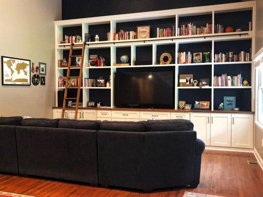 Custom living room bookcases with rolling ladder