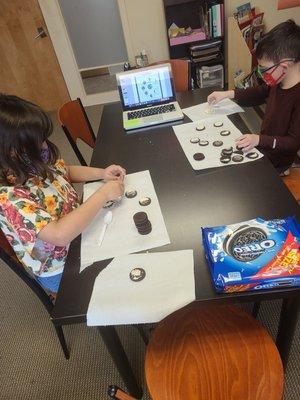 Using Oreo cookies to make the phases of the moon.