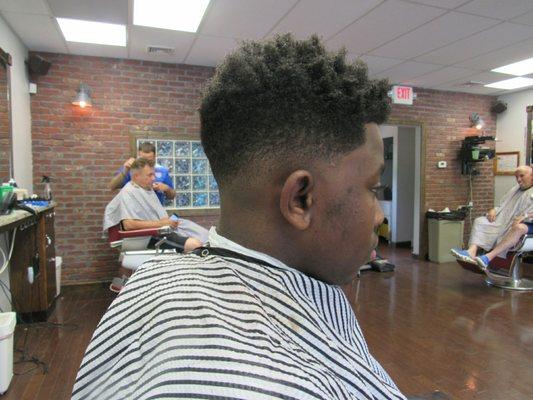 Low fade and curly on top from barber Josh..