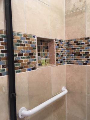 Rectangular tile trim in shower w/ squares of same tile to contrast in recess