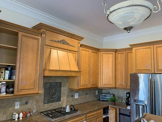 Before photo of kitchen cabinet refinishing and color change.