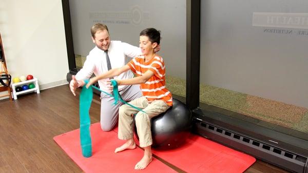 Evanston Chiropractor Dr. Benjamin Fergus uses pediatric chiropractic and pediatric physical therapy to help a boy with his sitting posture.