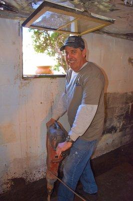 One of our in-house electrician's taking time out to help with the jack hammer