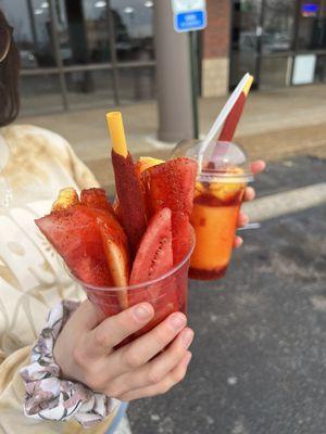 Fruit cup with tajin and chamoy with a tamarind candy stick