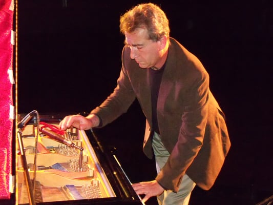 Steve Oliver preparing a piano for the Bill Mays trio at the Milford Theater.